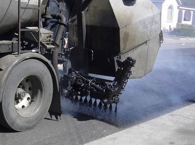 Machine Applying Surface Treatment to Street