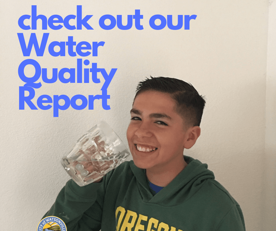 a happy young boy with a glass of tap water