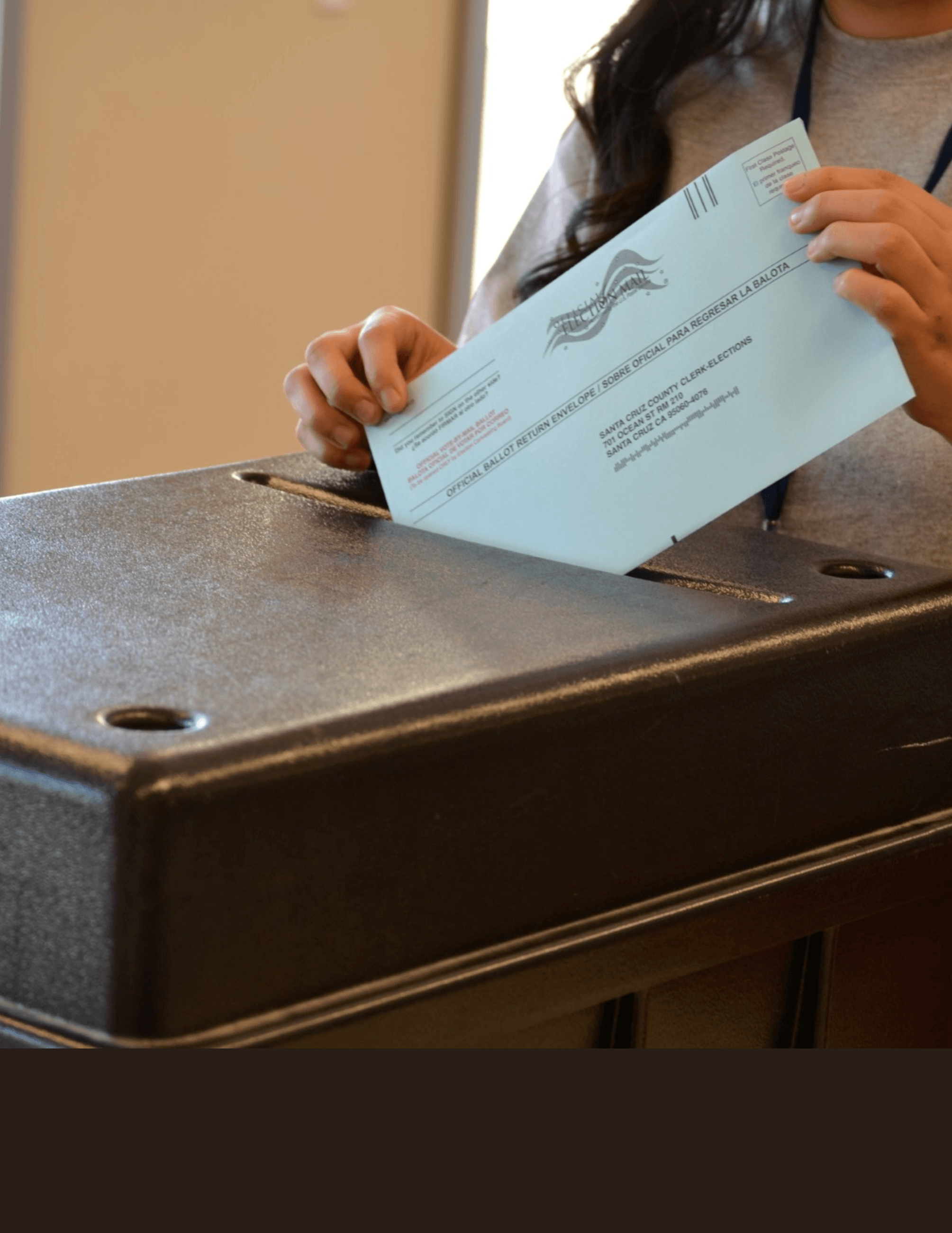 Person inserting ballot in ballot box 
