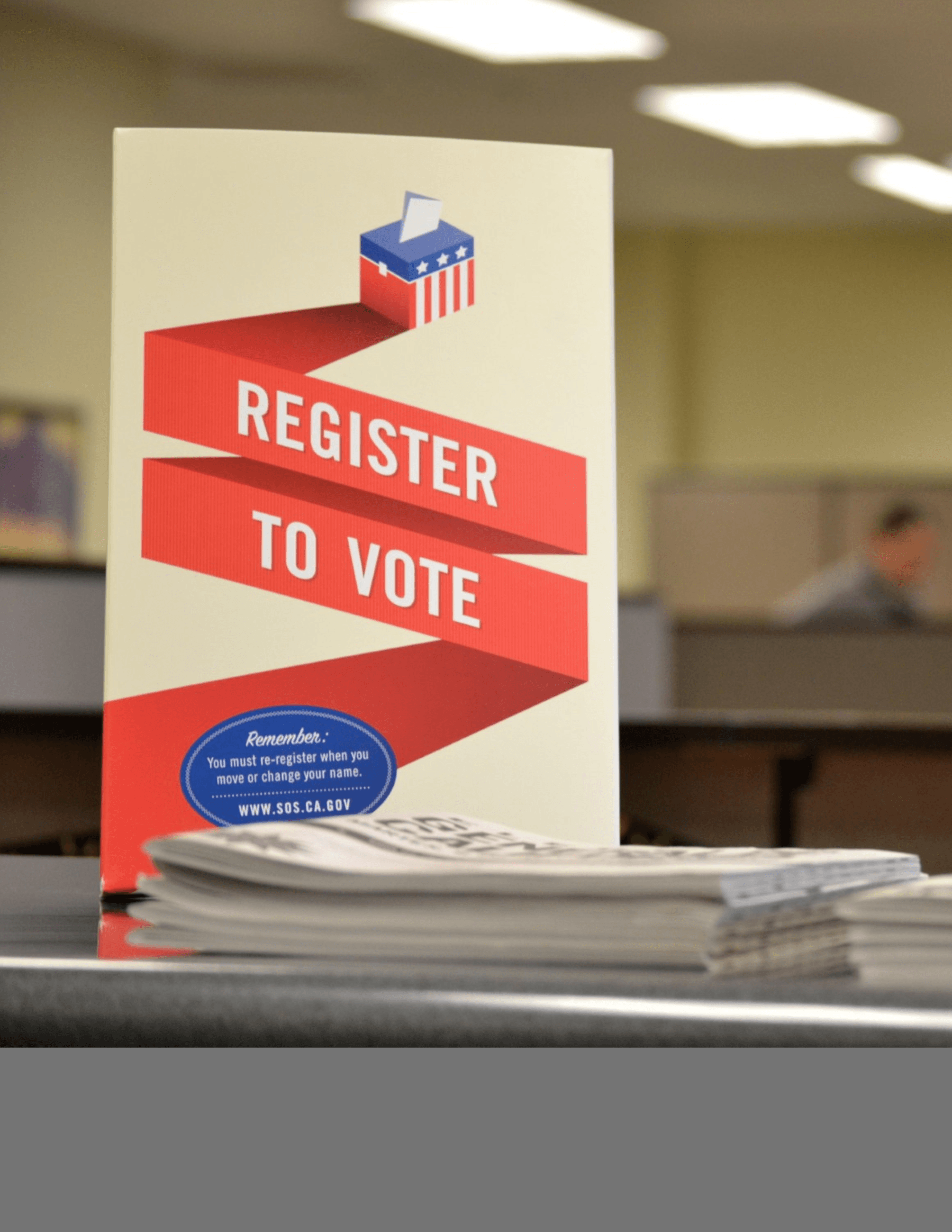 Sign at front desk encouraging people to vote 