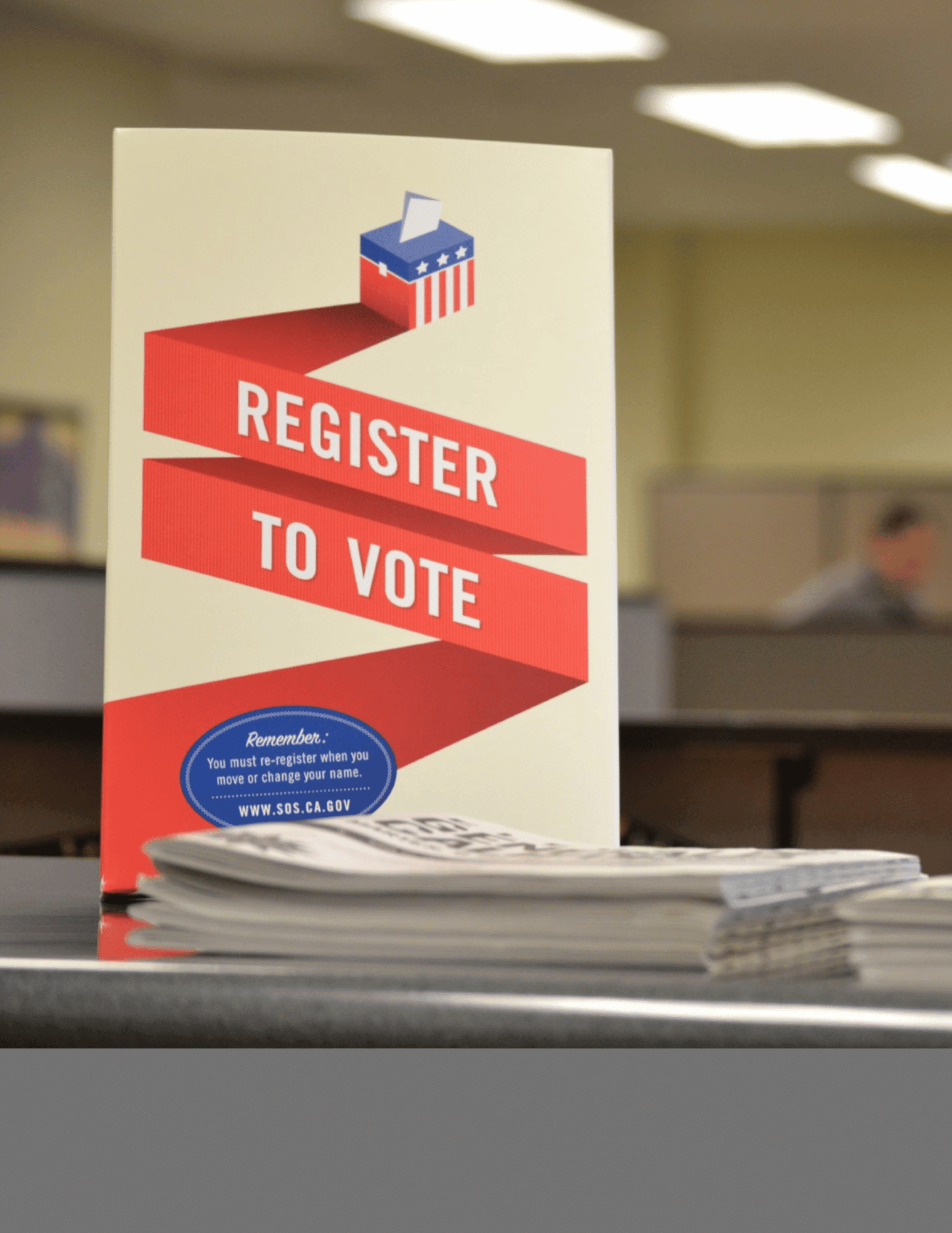 A sign in an office setting encouraging residents to vote 