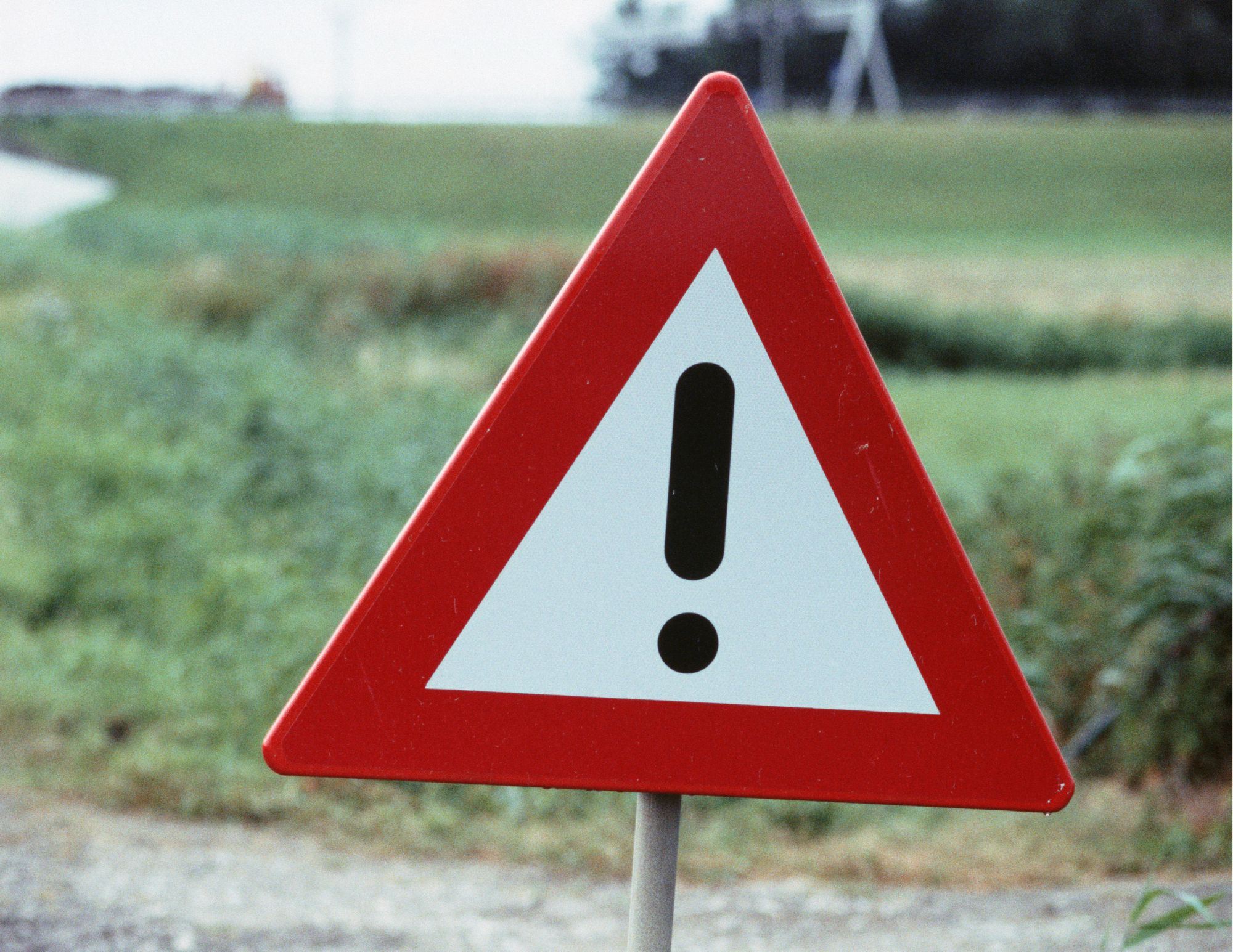 Photo of red triangular Hazard Sign with exclamation point in the center