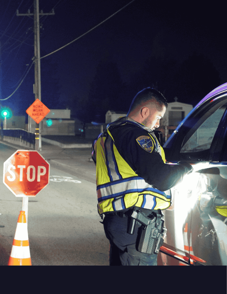 Officer checking driver license during a DUI checkpoint 