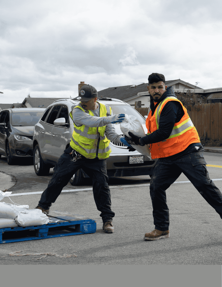 City of Watsonville employees loading up sandbags into a truck 
