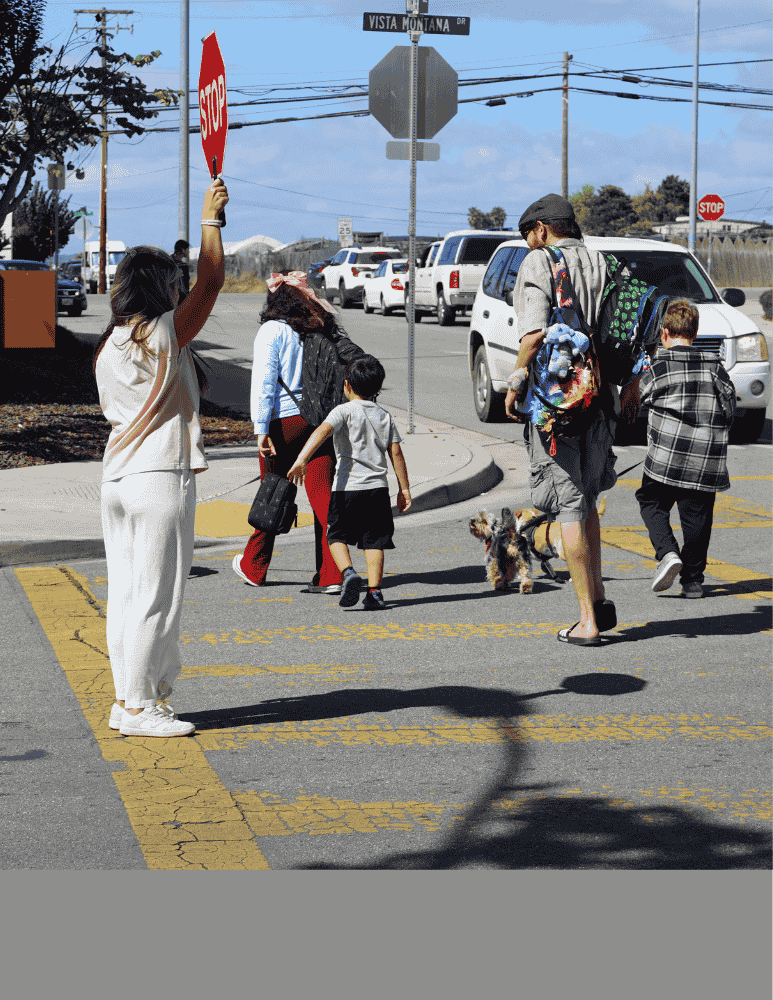 Kids and parents crossing the street after school 