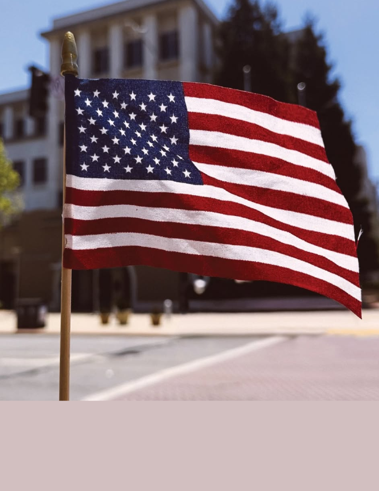 Mini American Flag being held in front of the Civic Plaza on Main Street 