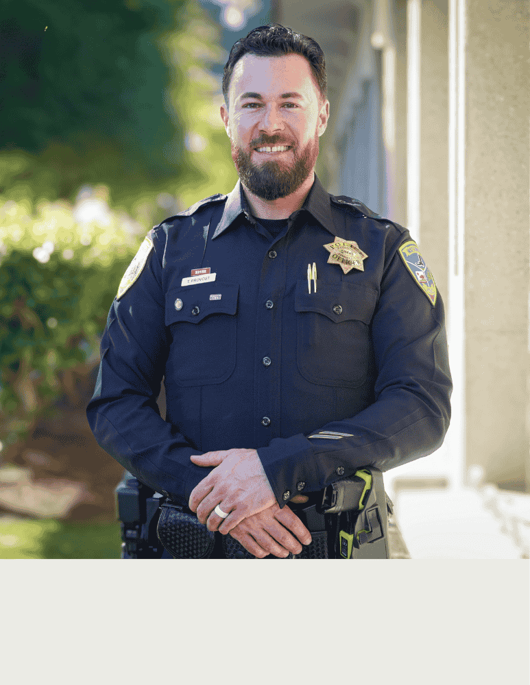 Officer Provost standing outside a City building posing for his headshot