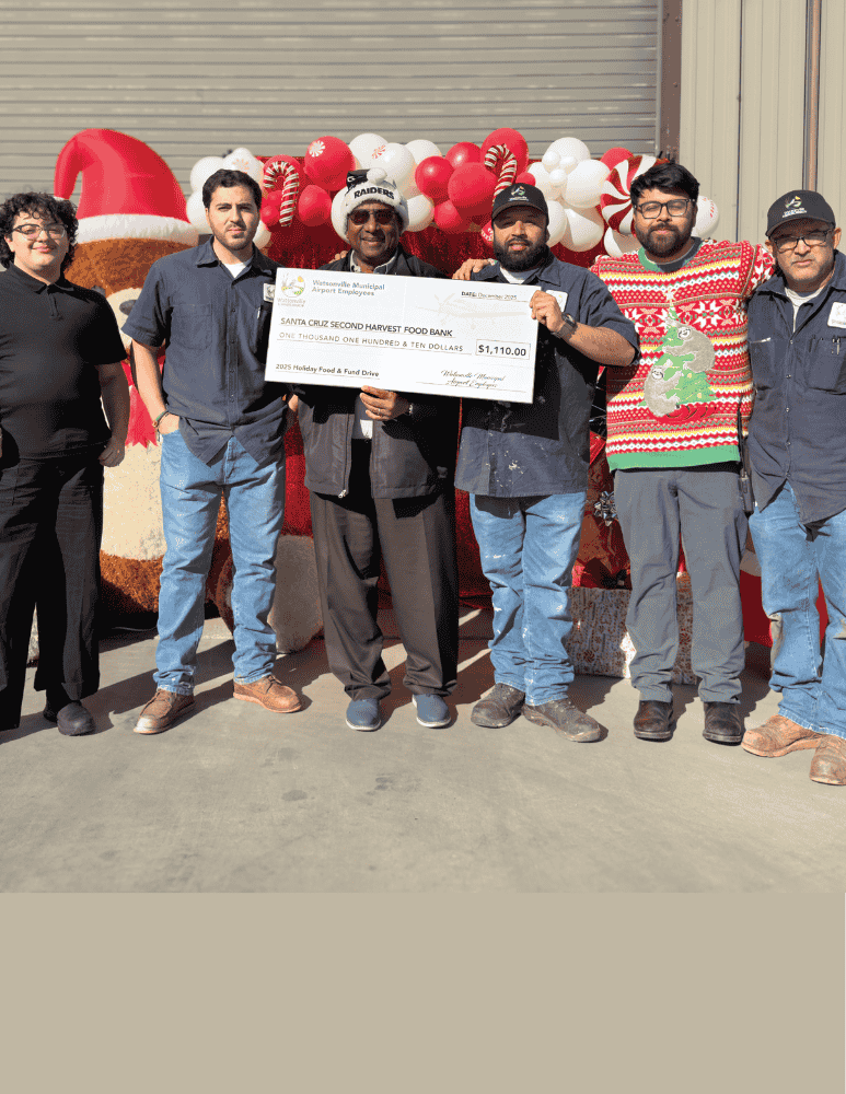 Airport Staff proudly holding a check they will donate to Second Harvest Food Bank