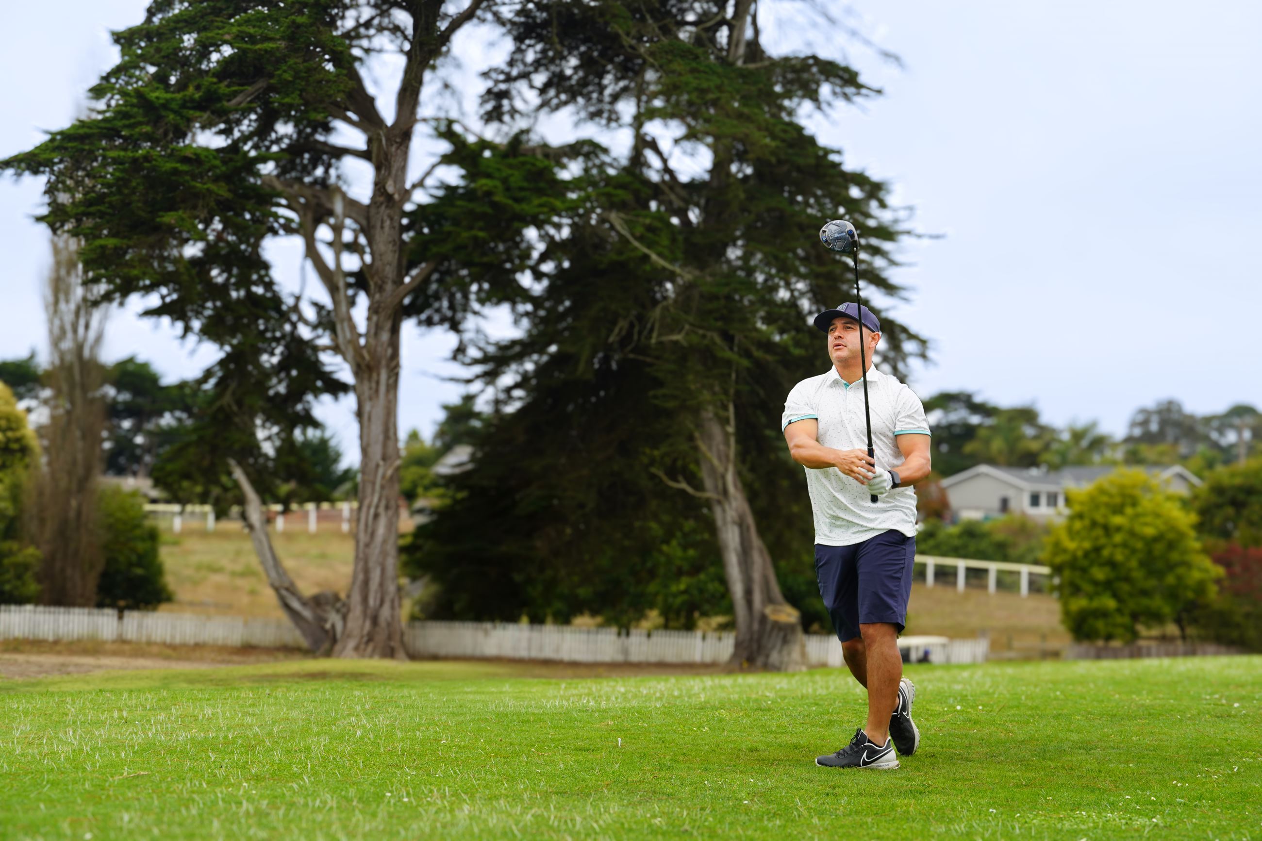 Golf player taking a full action swing